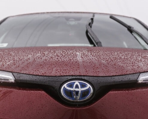 red toyota car in rain - Toyota Performance Chips Improve MPG